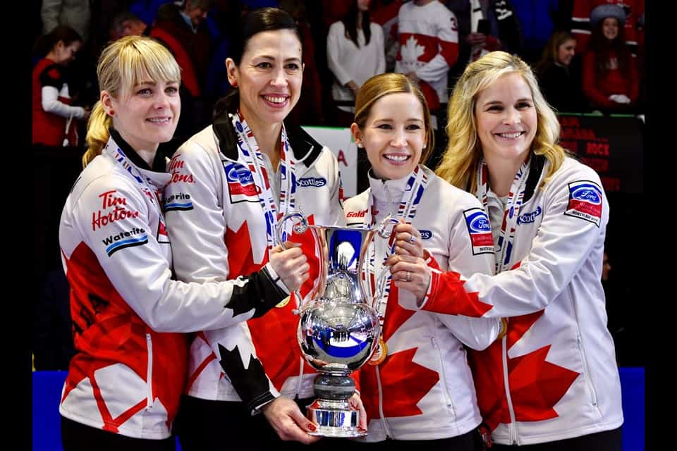 Women's Curling Championship team holding trophy