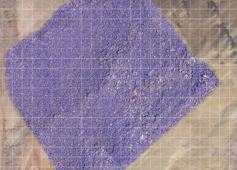 orthomosaic image of blasted rock with generated blue net around the particles