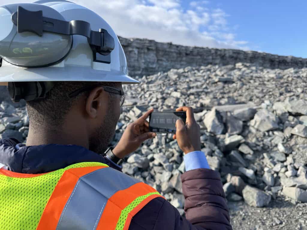 A person using WipFrag on a mobile device in a quarry